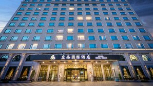 A multi-story hotel with a modern facade, large windows, and a prominent entrance with a sign. - Royal Chiayi Hotel (Chiayi City)