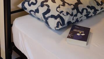 A bunk bed with a patterned pillow and a book on the bed.
