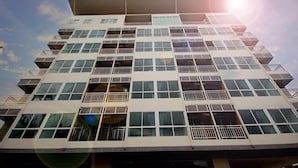 A multi-story building with balconies and large windows. - The Villa Chiangrai (Chiang Rai)
