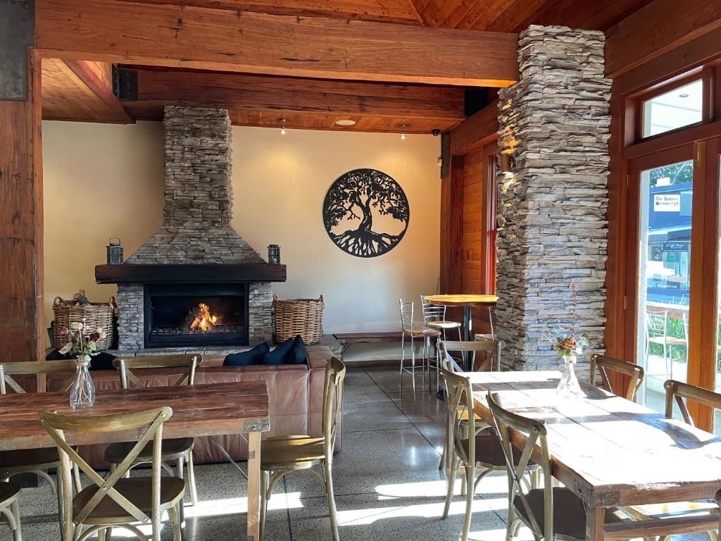A cozy interior with a fireplace, stone walls, and wooden furniture.