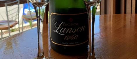 En flaske Lanson champagne og to glas på et bord.