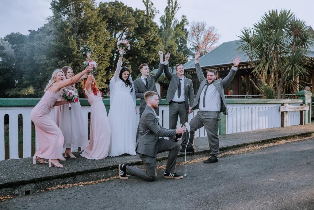A group of people on a bridge with a building in the background.