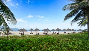 Pantai pribadi, pasir putih, kursi berjemur, dan payung pantai