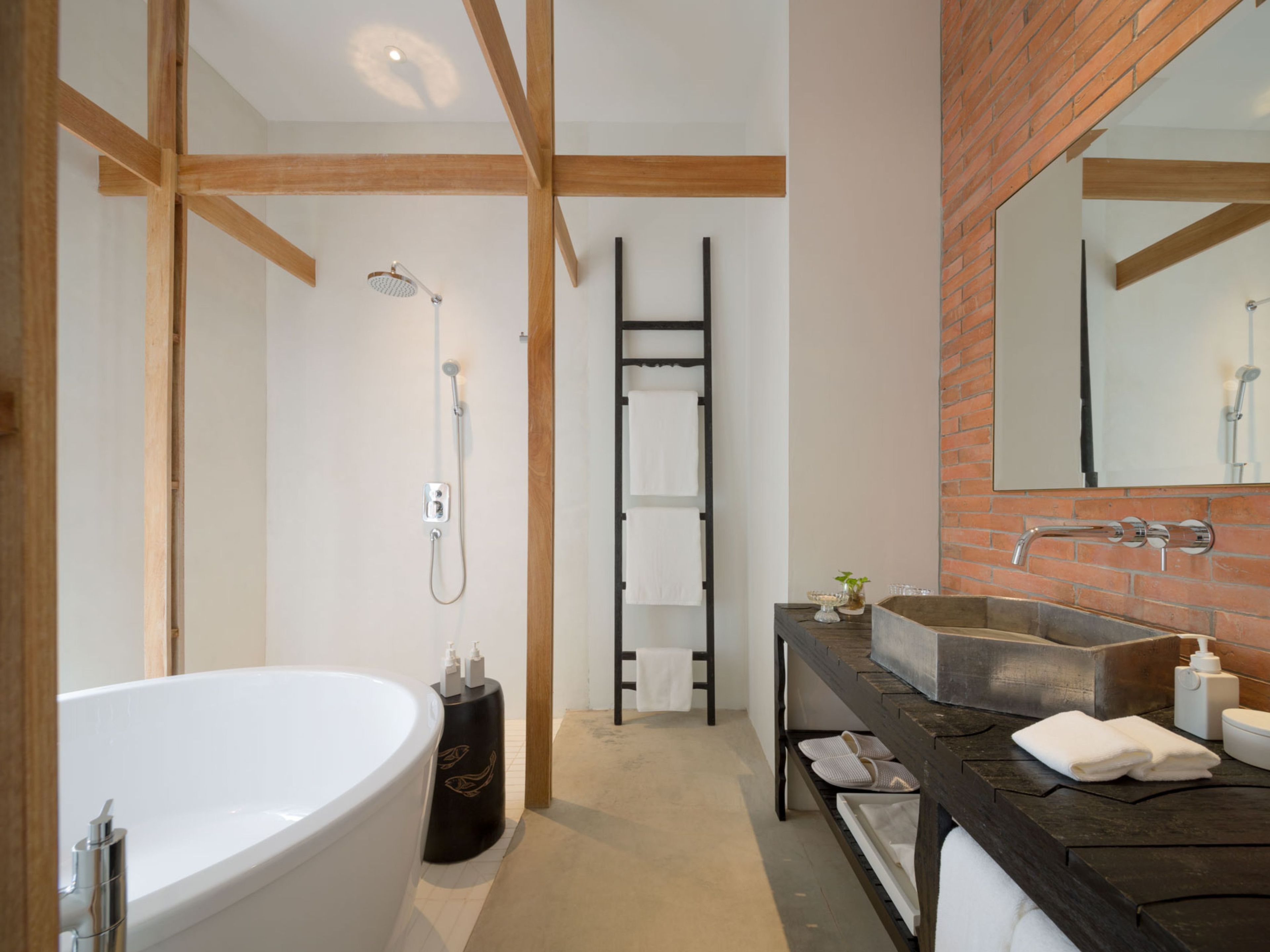 A modern bathroom with a freestanding bathtub, a shower, and a vanity with a large mirror.