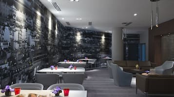 A modern interior with a cityscape mural, dining area, and seating.