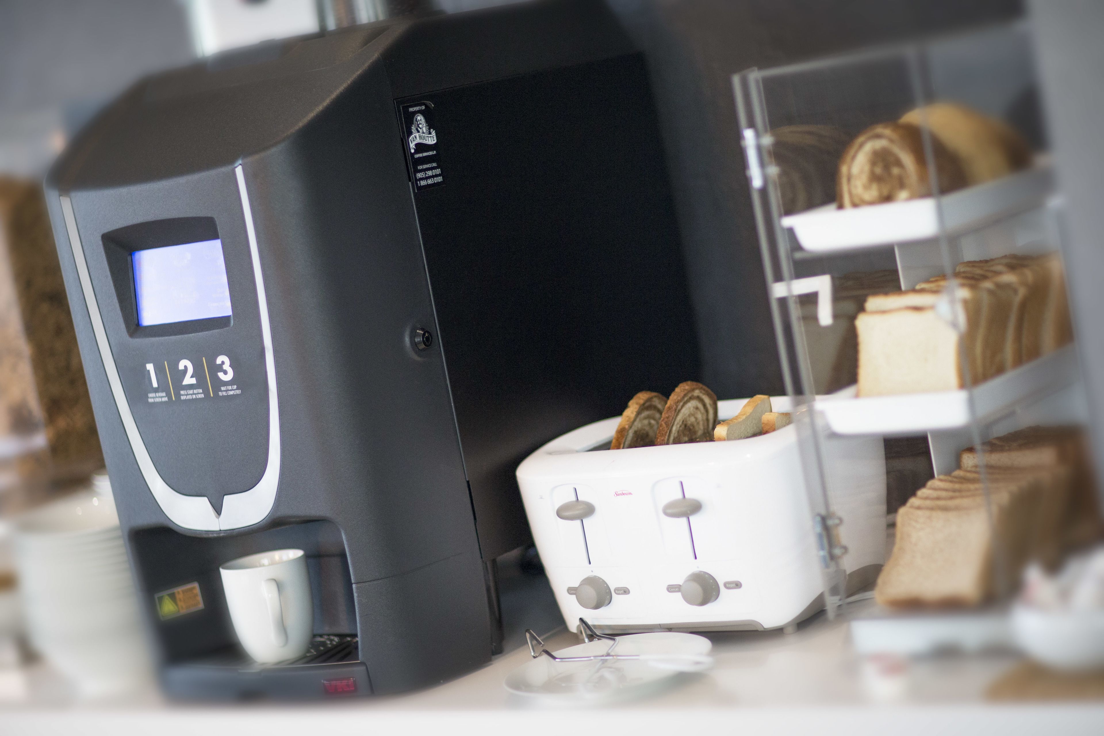 A coffee machine with a digital display and a bread display unit.