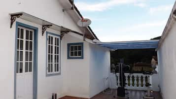A white building with blue-framed windows and a satellite dish.