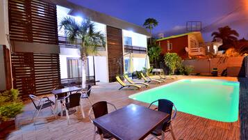 Una piscina al aire libre, sombrillas