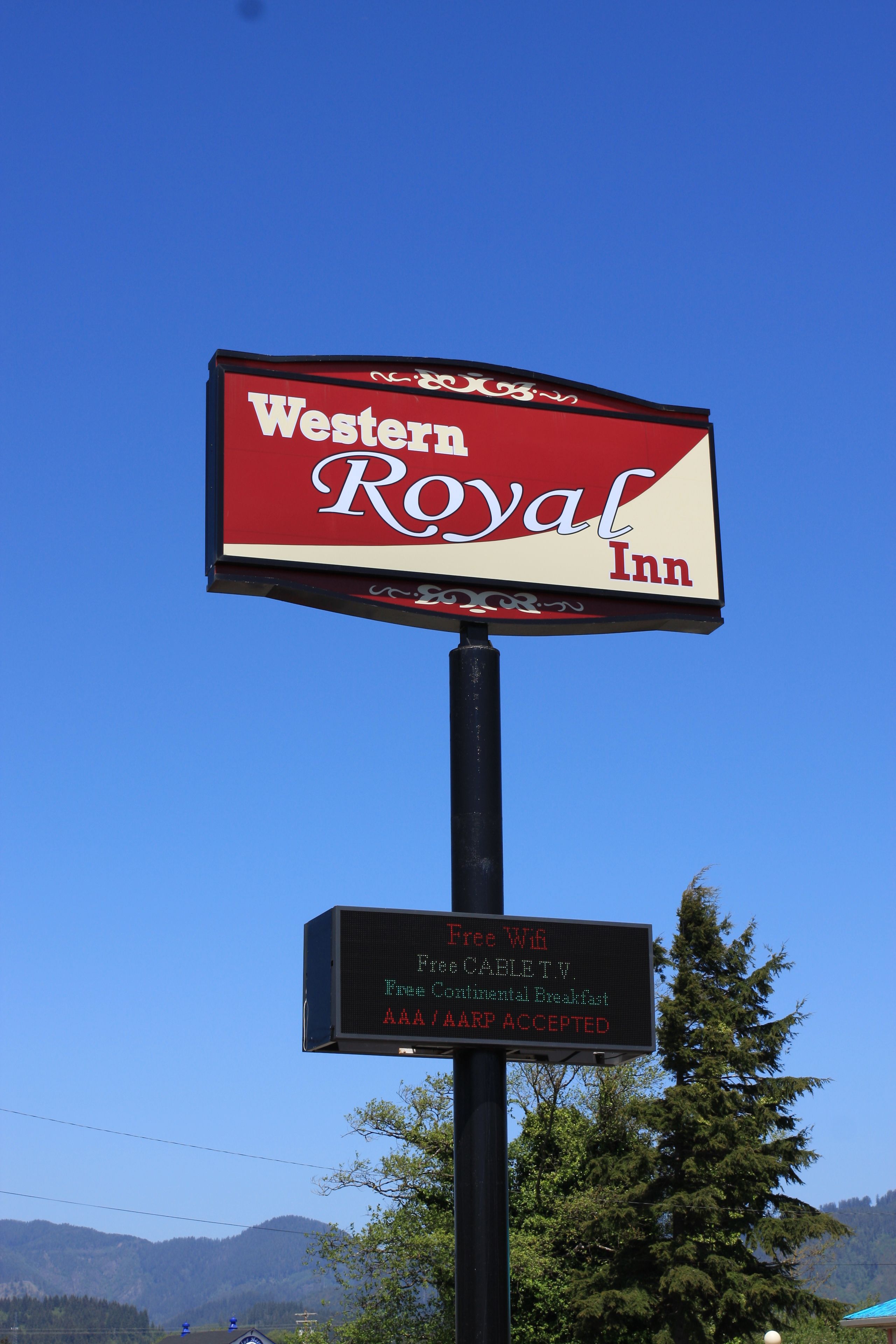 A Western Royal Inn signboard with a clear sky background.