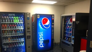 Three beverage vending machines with a Pepsi logo, one with an Aquafina logo, and a snack vending machine.