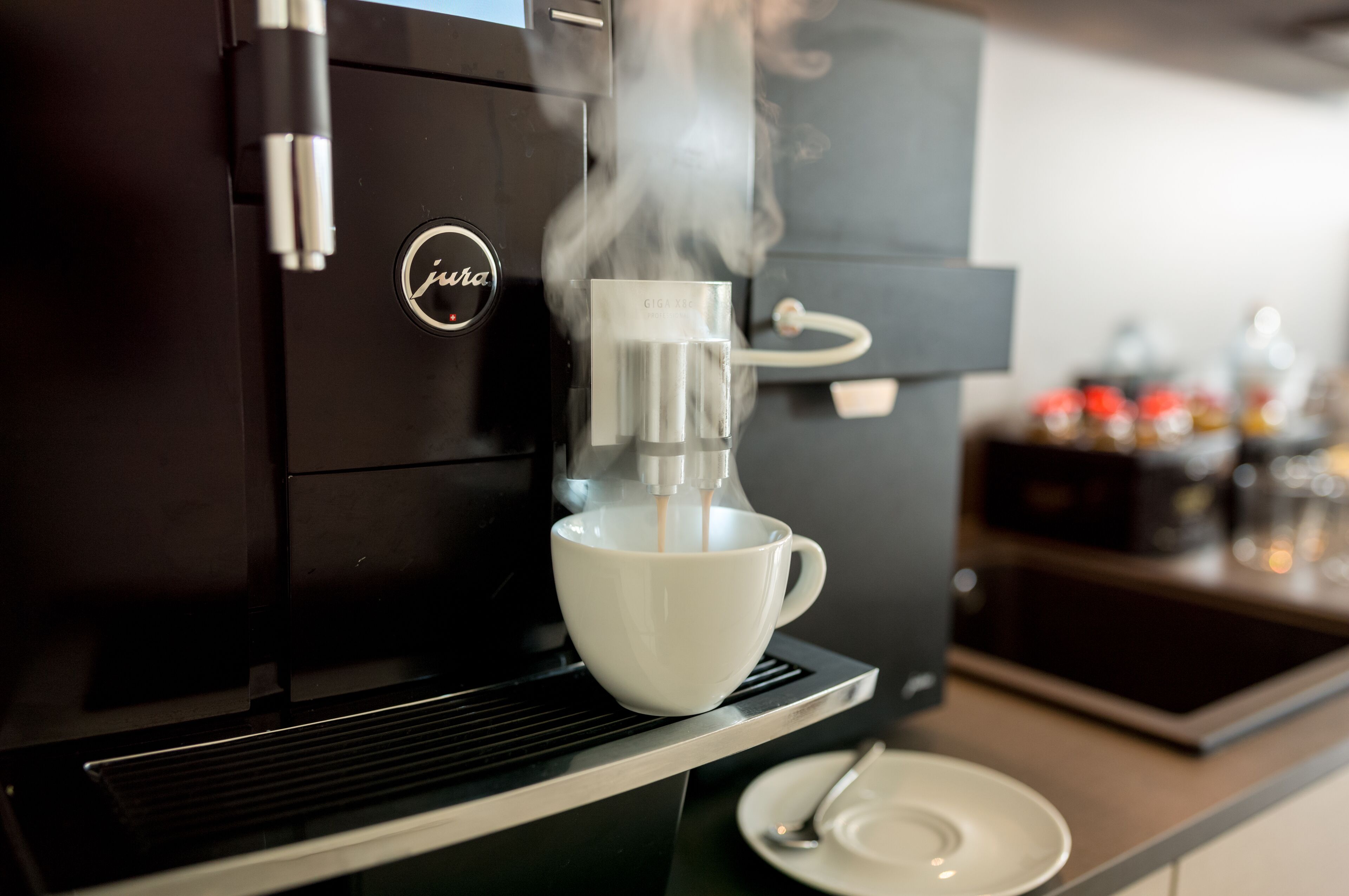 A coffee machine dispensing coffee into a cup.