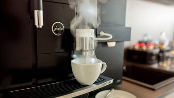 A coffee machine dispensing coffee into a cup.