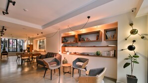 Ein modernes Interieur mit einer Sitzecke, Bücherregalen und einem Blumentopf.