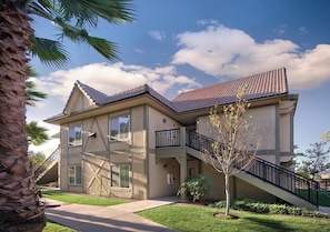 A two-story house with a tiled roof, a balcony on the second floor, and a staircase leading to the entrance. - WorldMark Solvang (Solvang)