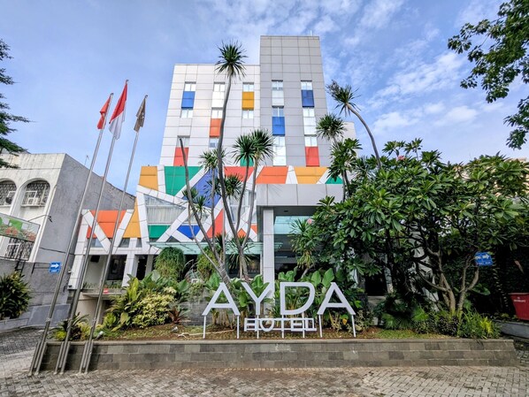 A hotel with a colorful facade and a sign that reads "AYDA HOTEL".