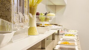 A buffet setup with various food items and condiments. - Taximist Hotel (Istanbul)