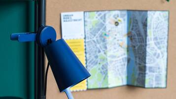 A blue object attached to a wall with a map in the background.