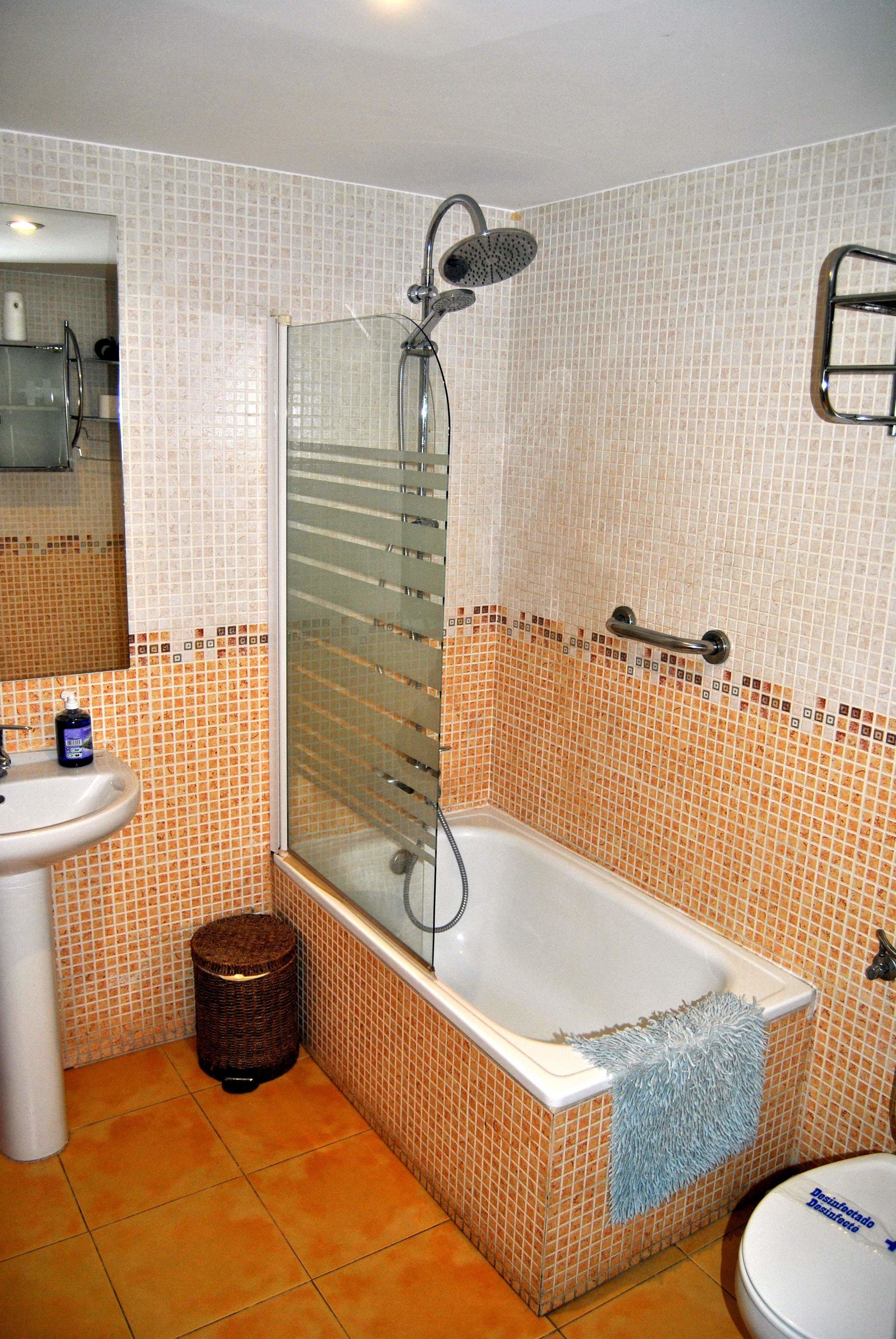 A bathroom with a bathtub, a sink, and a toilet.