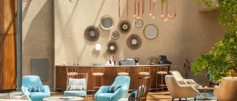 A modern lounge area with a bar, multiple seating options, and decorative wall art.