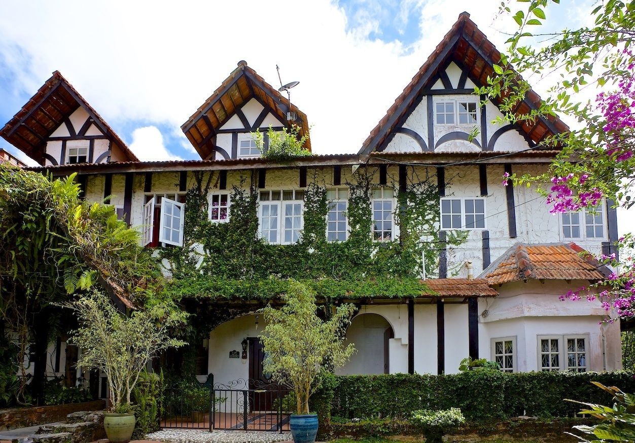 A traditional building with a symmetrical facade, multiple windows, and a central entrance.