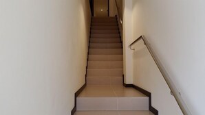 A staircase with a handrail, leading to an upper floor. - 118 Hotel (George Town)