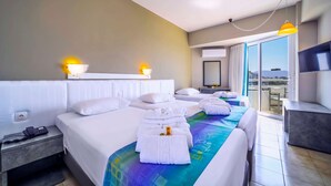 A hotel room with a large bed, a bedside table with a phone, a bathroom with a mirror, and a TV on the wall. - Lito Hotel (Rhodes)