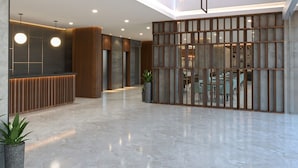 A spacious lobby with a reception desk, modern lighting fixtures, and a view of the dining area. - Citadines Connect Airport Jakarta (Jakarta)