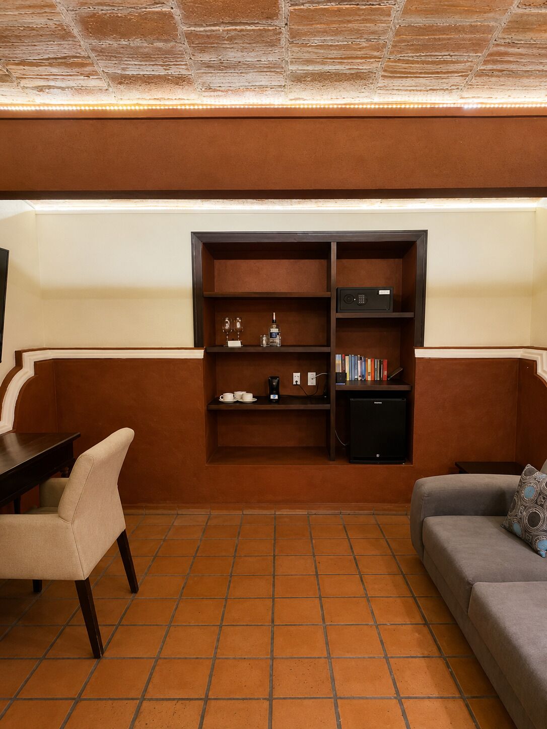 A living room with a sofa, a coffee table, a TV, and a bookshelf.