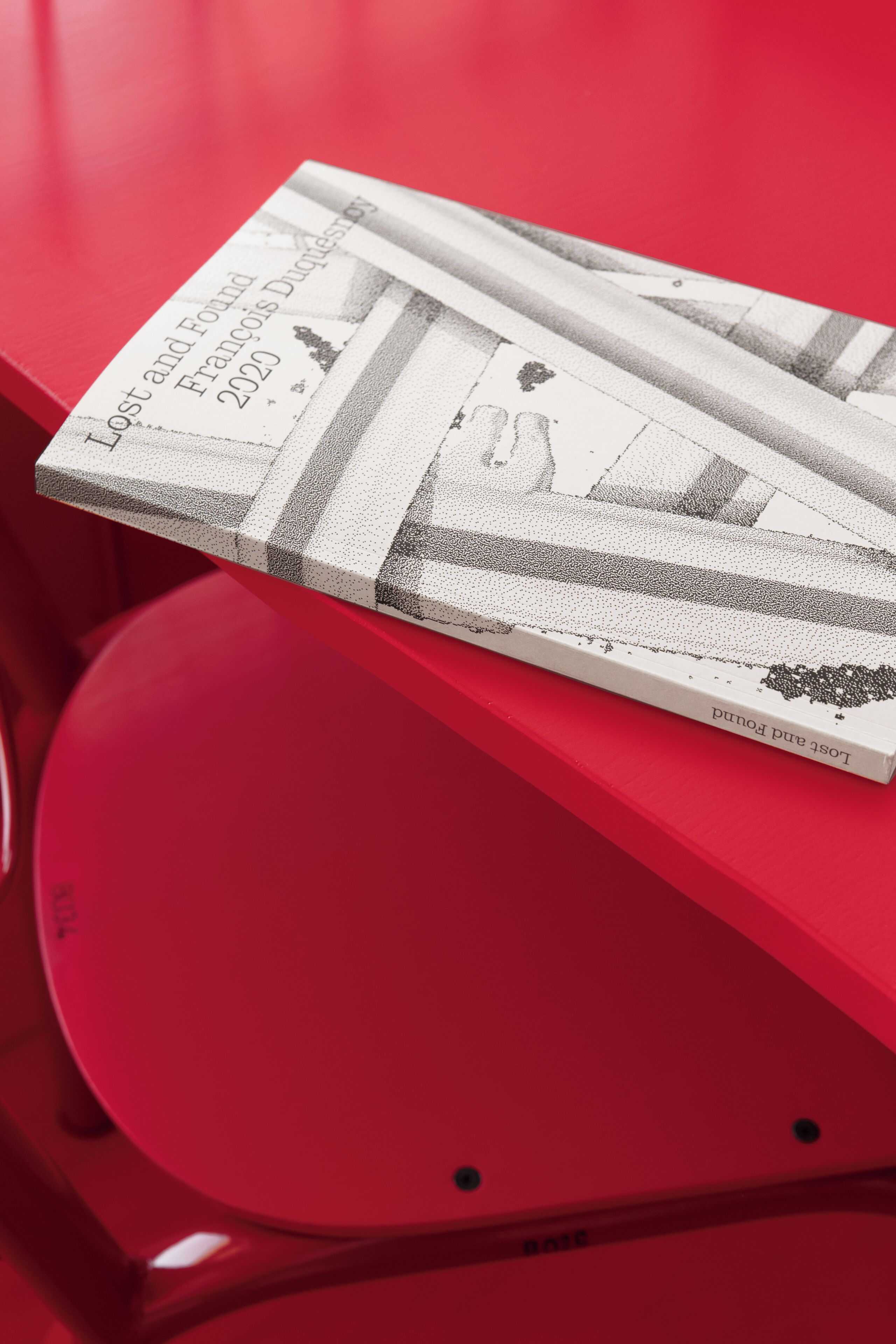 A book titled "Lost and Found" on a red surface.
