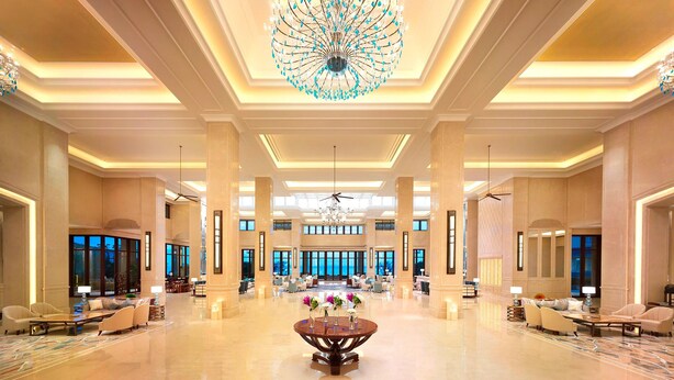 A spacious lobby with a large chandelier, seating areas, and a central table with flowers. - The Westin Zhujiajian Resort, Zhoushan (Zhoushan)