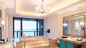 A luxurious bathroom with a large mirror, a chandelier, and a view of the ocean. - The Westin Zhujiajian Resort, Zhoushan (Zhoushan)