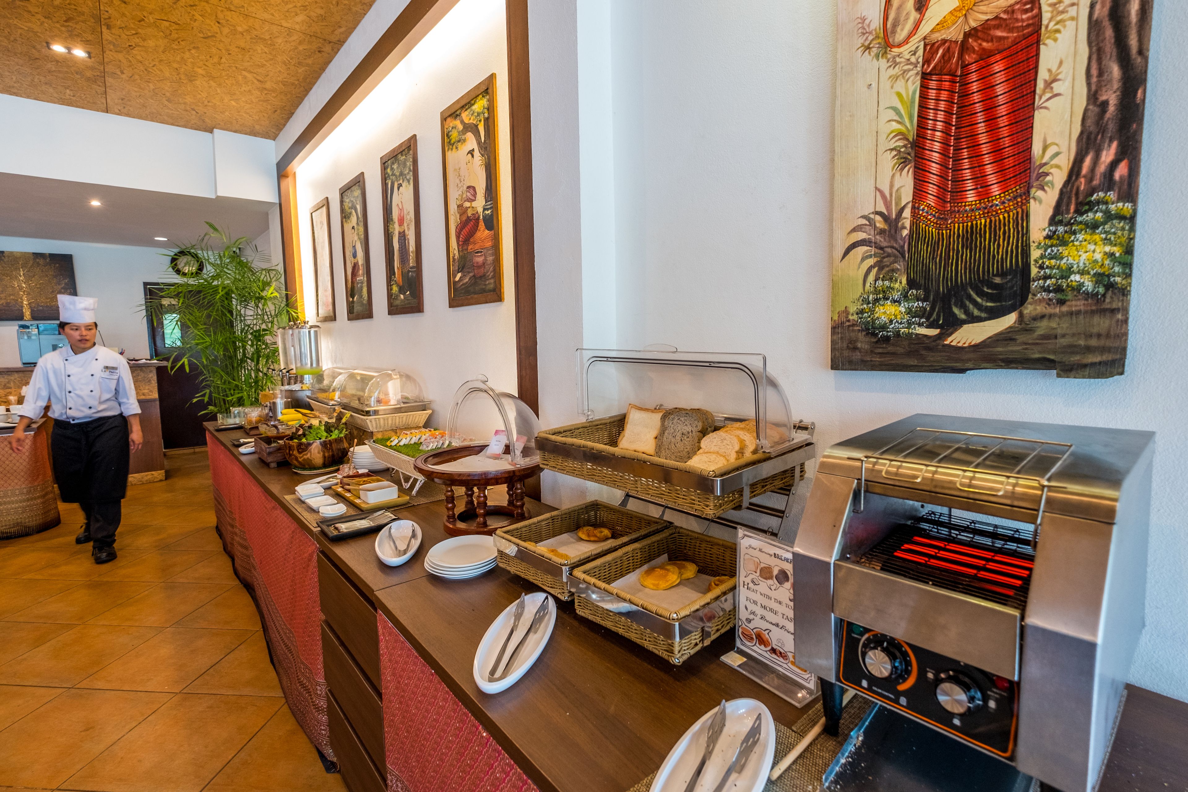 A buffet setup with various food items and a toaster oven.