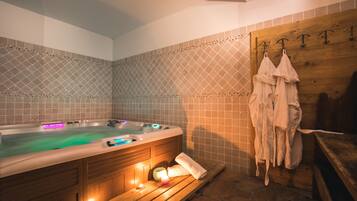 Relax in a spacious bathroom with a hot tub and a wooden bench.