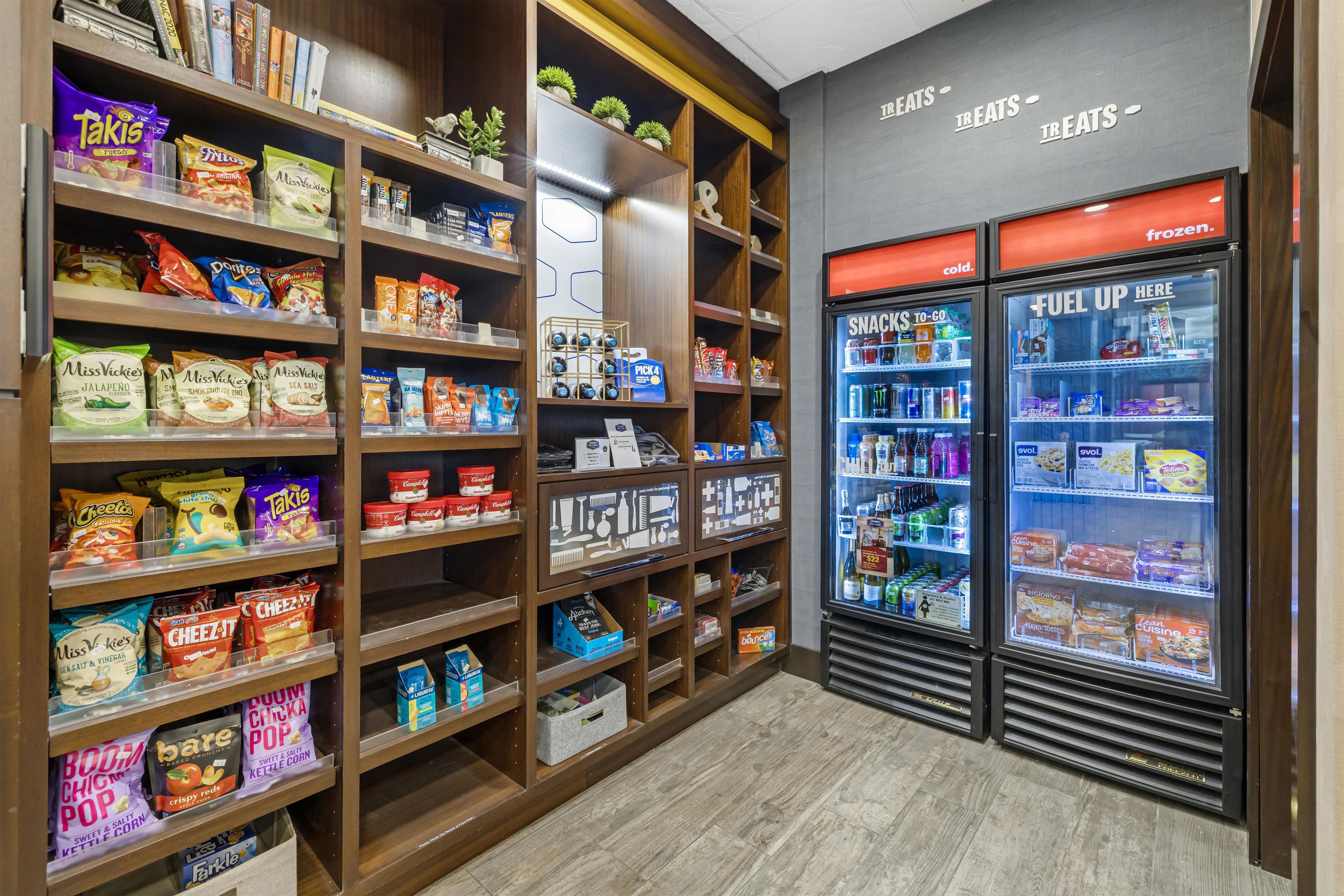 A snack and beverage section with shelves stocked with various snacks and a freezer area.