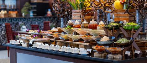 A buffet with various food items and condiments.