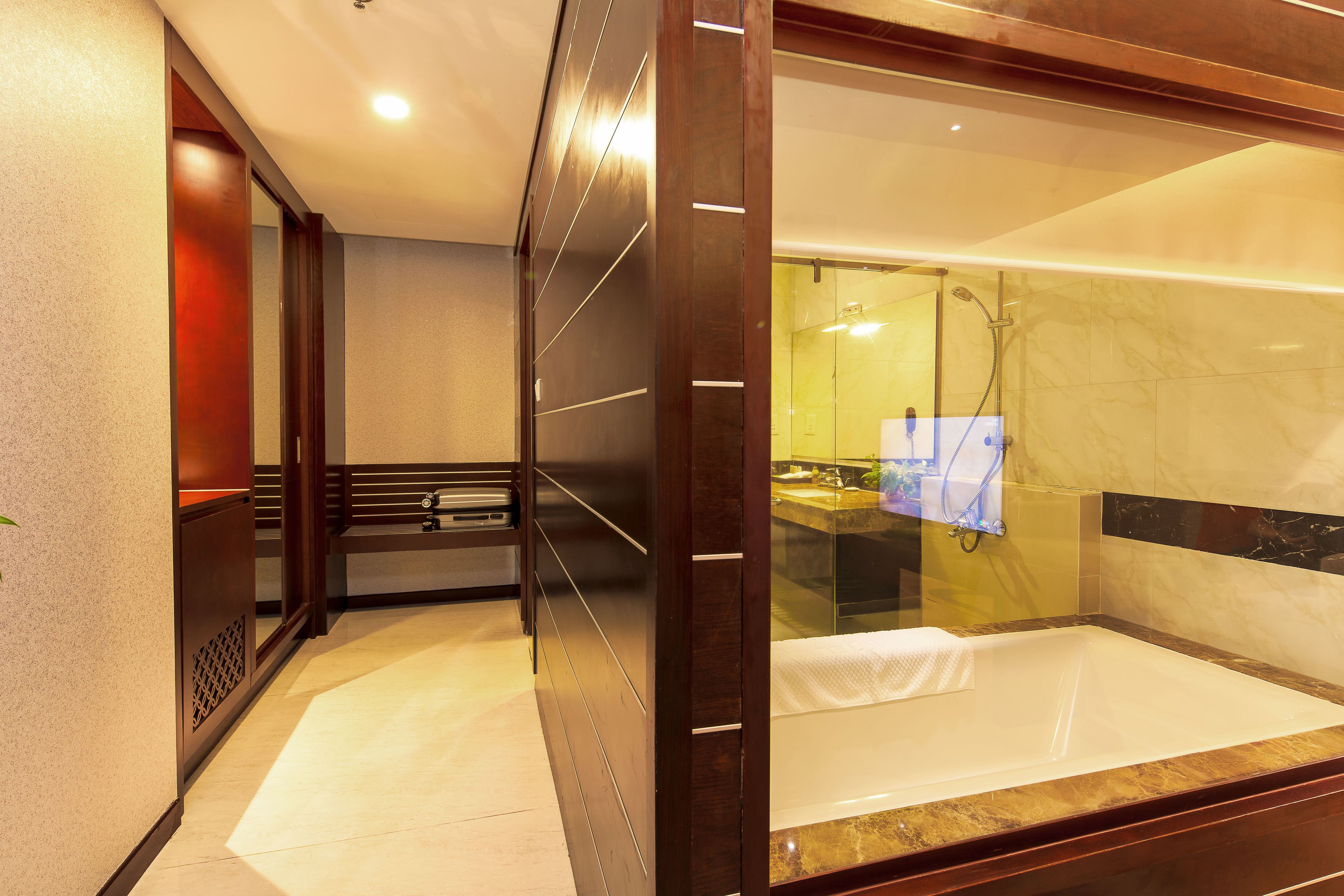 A modern bathroom with a glass-enclosed shower, a bathtub, and a vanity with a mirror.