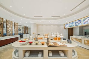 A modern, well-lit room with a central island, seating, and a large flat-screen TV. - Huhua International Hotel (Shanghai Wujing Hua Normal University Branch) (Shanghai)