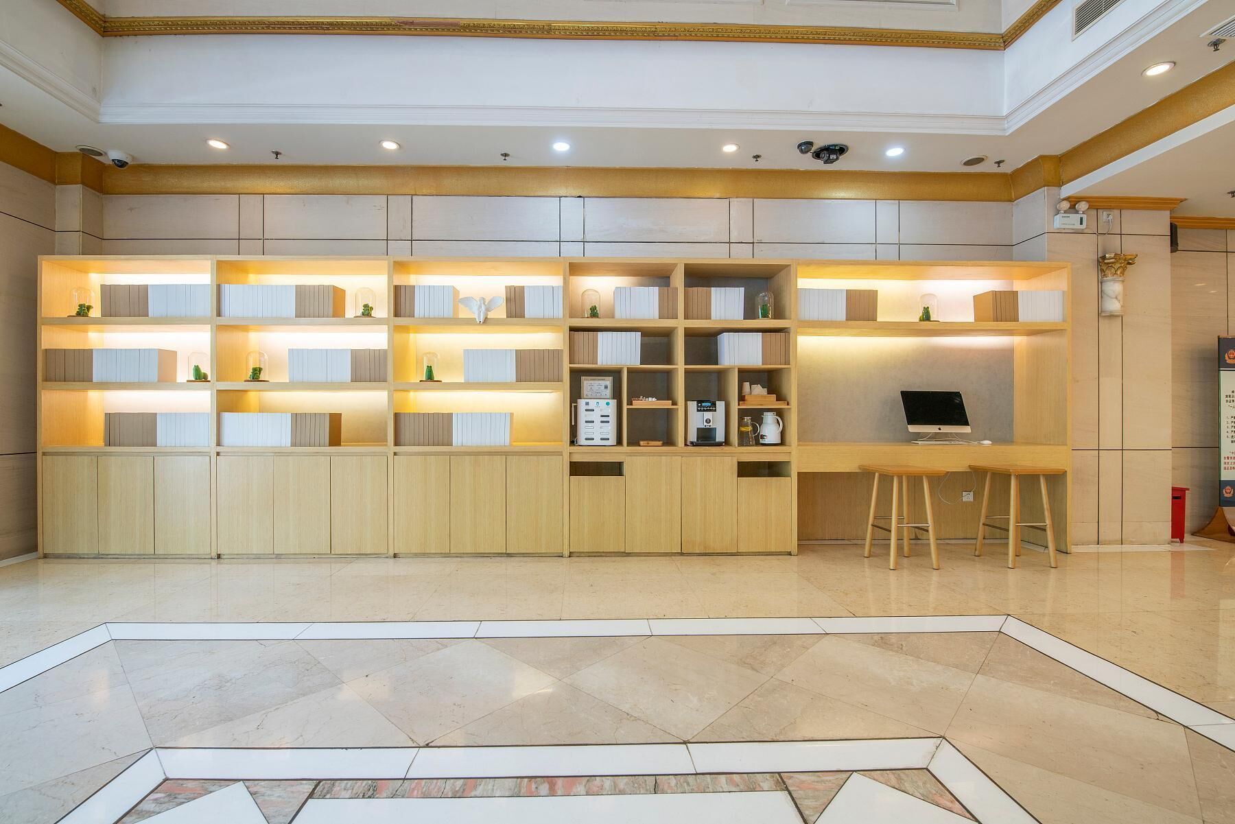 A modern kitchen with built-in cabinets, a countertop, and a bar area with stools.