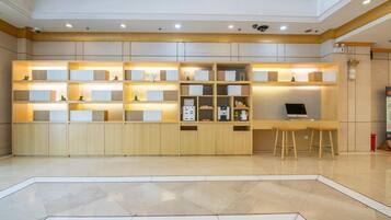 A modern kitchen with built-in cabinets, a countertop, and a bar area with stools.