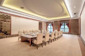 A conference room with a long table, chairs, and a carpeted floor. - Evergrande World MICE Center (Jintang)