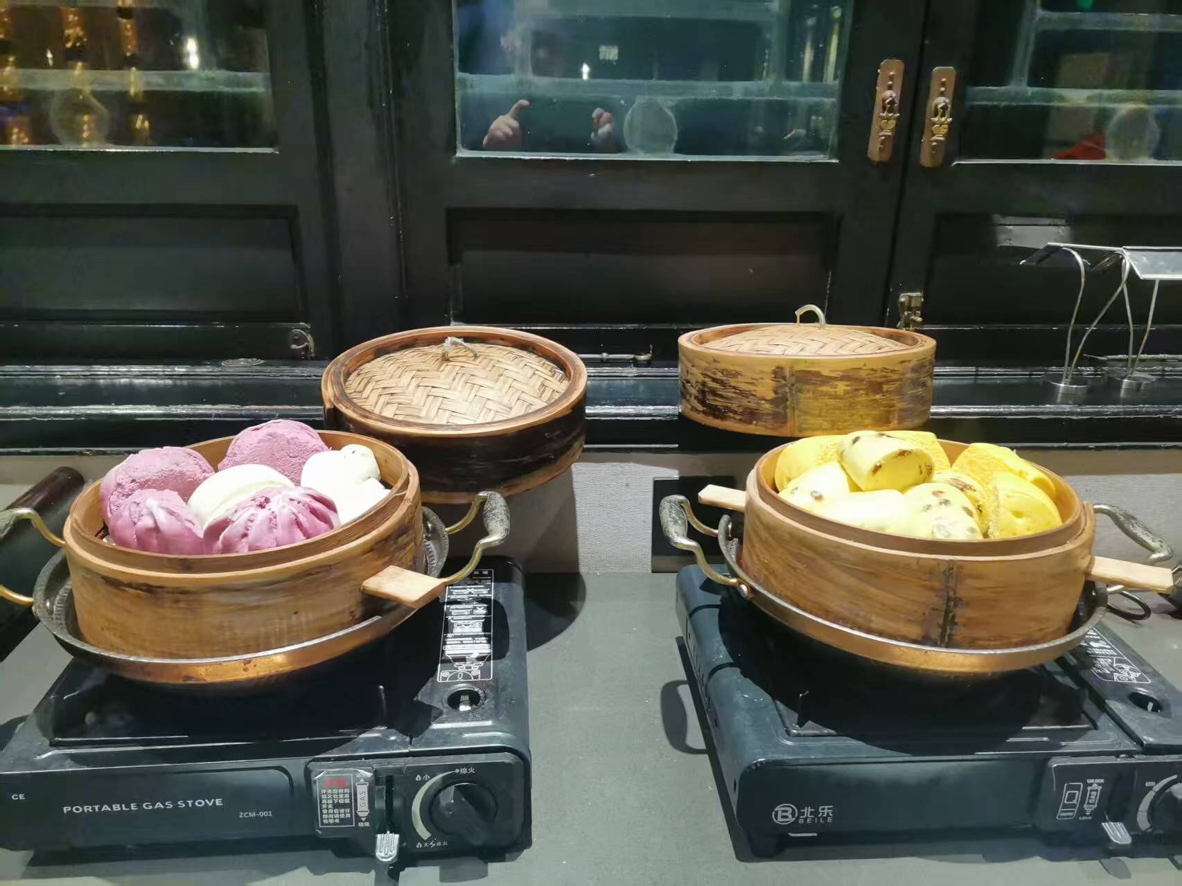 A portable gas stove with two cooking pots on it.
