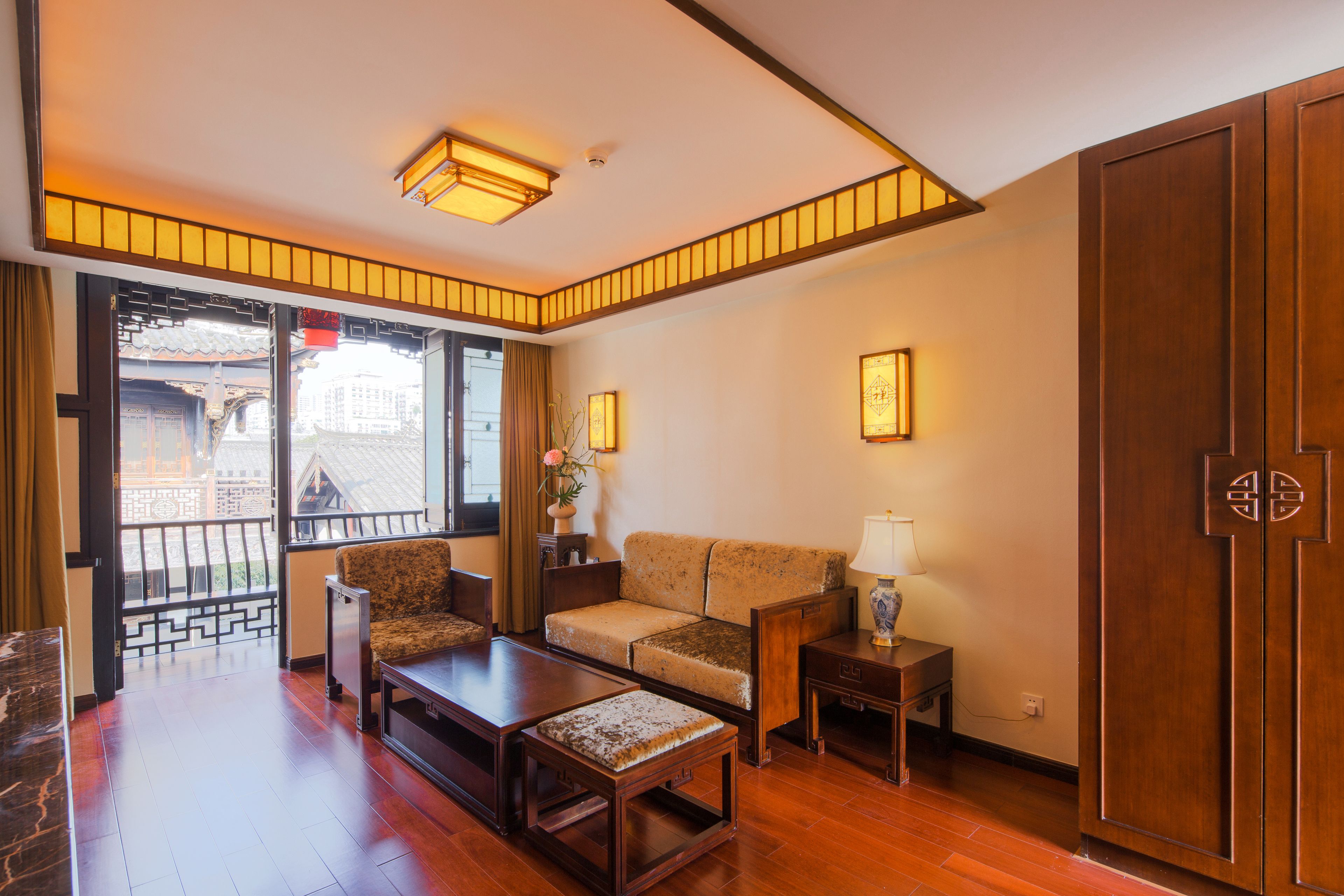 A spacious living room with a wooden floor, a sofa, a coffee table, and a TV.
