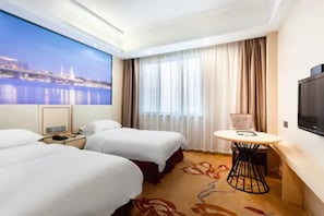 A hotel room with two beds, a small table, a TV, and a large window with a cityscape view. - Vienna International Hotel (Suzhou Likou Furniture City) (Suzhou)