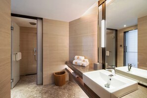 A modern bathroom with a large mirror, a sink, and a shower area. - Fliport Garden Hotel Xiamen (Xiamen)