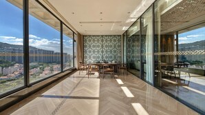 Ein geräumiger Balkon mit modernem Design, mit einem Fischgrätparkettboden und Blick auf die Stadtlandschaft.
