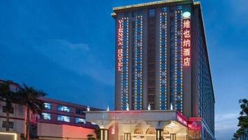 A tall hotel building with multiple floors and a prominent entrance.