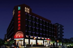 A multi-story hotel with illuminated signage and a prominent entrance. - Beijing Henan Business Hotel (Beijing)