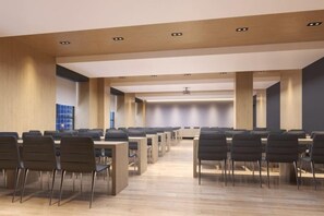 A conference room with multiple tables and chairs, wooden paneling on the walls, and recessed ceiling lighting. - Nanyuan Ejiaplus Hotel (Ninghai Xizi International) (NINGHAI)