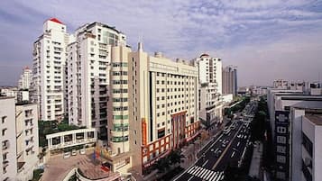 A multi-story hotel with a central courtyard, surrounded by high-rise buildings.