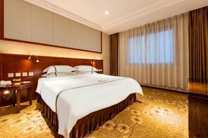 A hotel room with a large bed, a nightstand, a desk, and a window with curtains. - Haotian Holiday Hotel Beijing (Beijing)